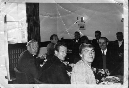 Men at a table, by their dress the 1960s