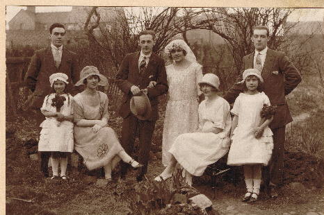 A wedding group in a garden, 1920s